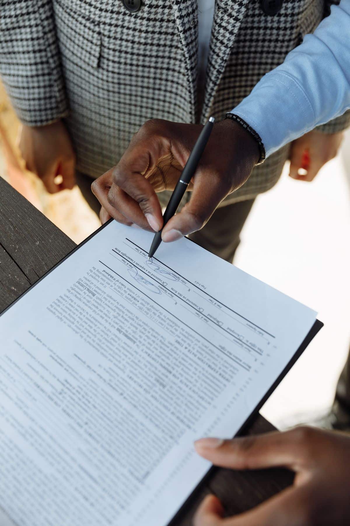 Person signing a business contract with a pen