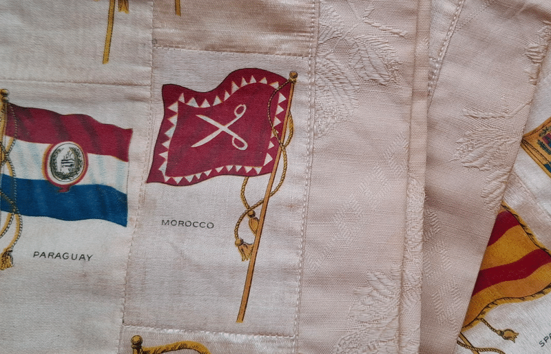 Detail of the silk table runner: flags of Paraguay and Morocco