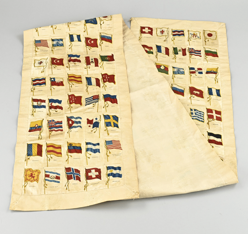 Silk table runner made from cigarette silks with flags of many countries